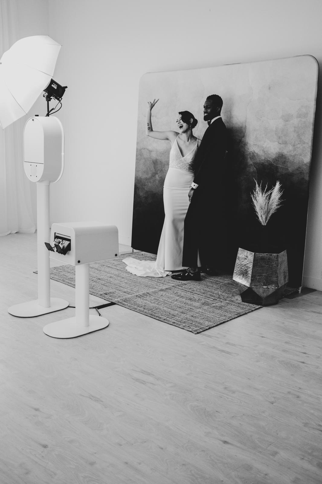 Newlyweds at The Flash Bar photobooth backdrop
