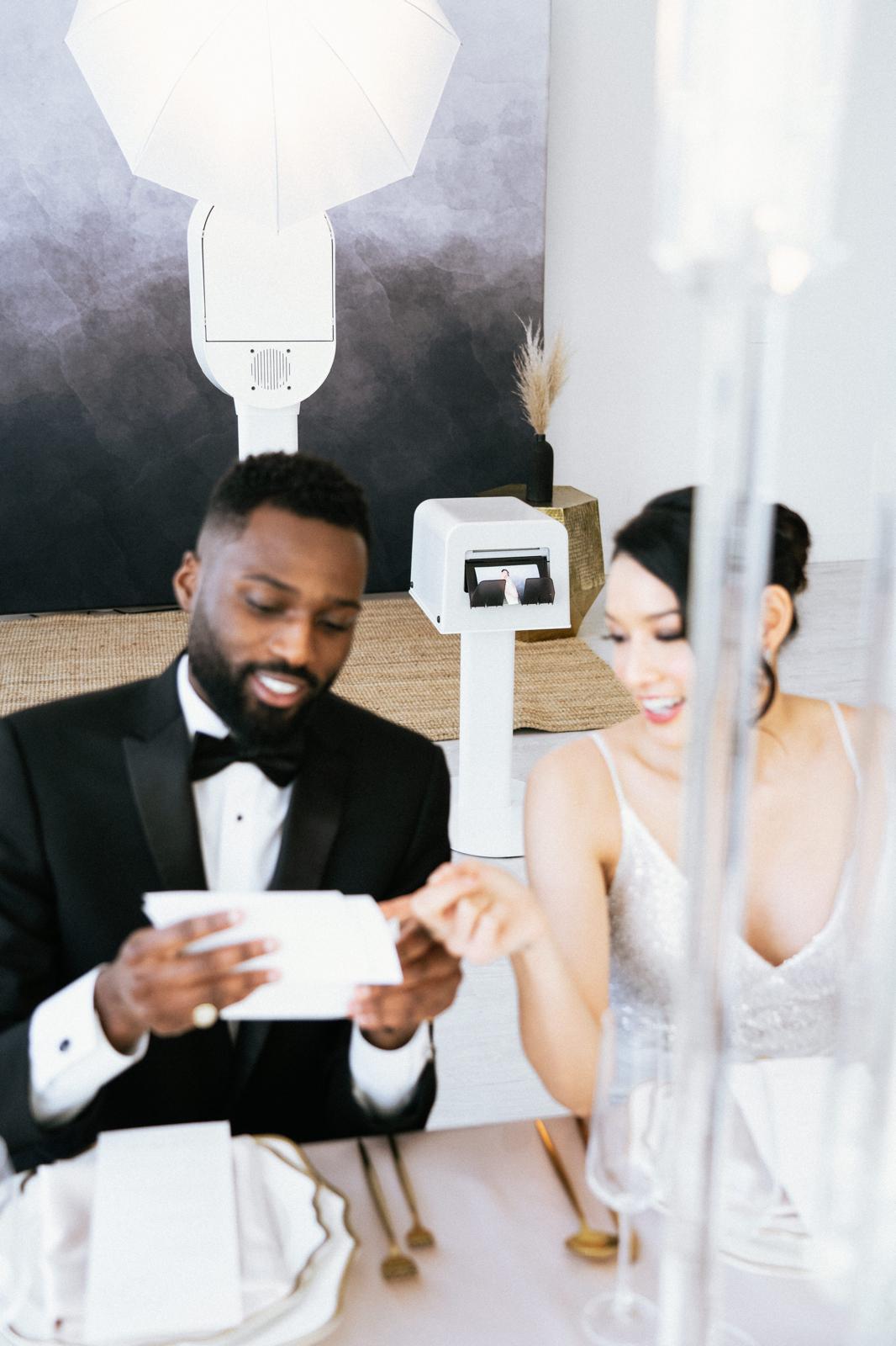 Newlyweds looking at their photo strip from The Flash Bar photobooth